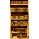 Six shelves of leather bound books, mostly relating to literature including Thackeray's Works,