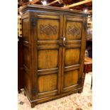 Jacobean style linen press, the rectangular molded cornice above a double paneled and carved