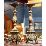 Pair of brass repousse candle prickets, each rising on tripartie sculpted base, 15"h.