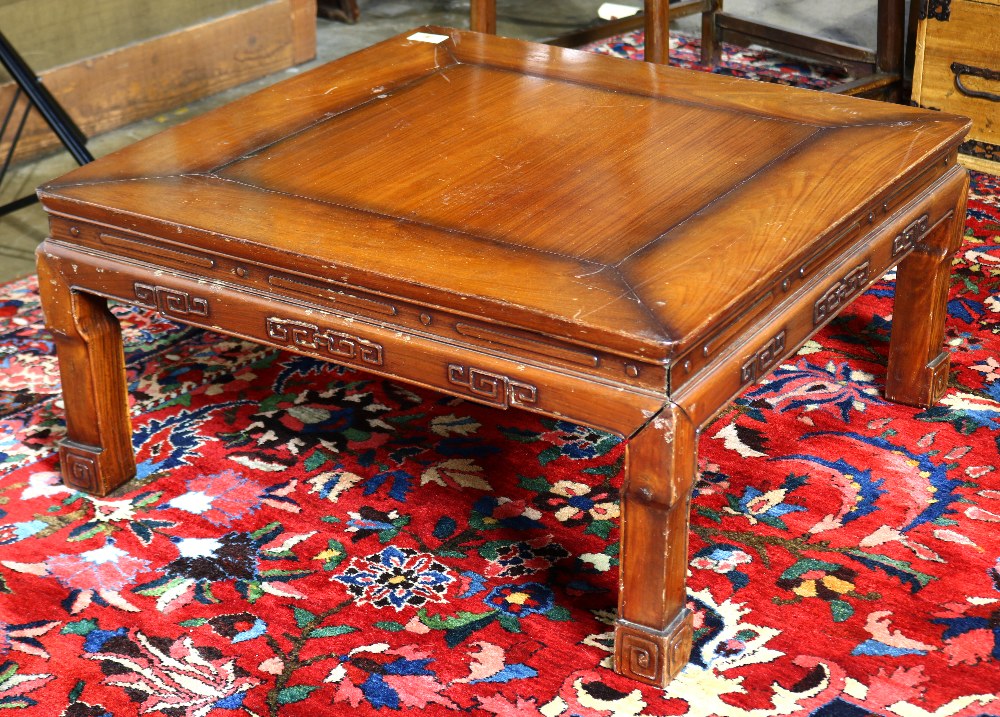 Chinese square low table, with a square floating panel, above an apron carved with scrolls in