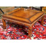 Chinese square low table, with a square floating panel, above an apron carved with scrolls in