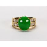 Jadeite, diamond and 18k yellow gold ring Featuring (1) oval jadeite cabochon, measuring