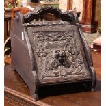Renaissance style carved coal scuttle, the carved front featuring scrolling foliage framing centered