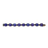 Tanzanite, silver and 14k yellow gold bracelet Featuring (9) oval tanzanite cabochons, measuring