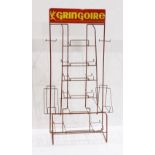 French enamel decorated display stand, the top inscribed "Gringoire" in yellow, above the red