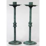 Pair of modern green patinated candle holders, having a wide bobeche over the skinny cylindrical