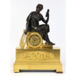 French Empire gilt and patinated bronze clock circa 1810, having a Scholar and lyre figural mount