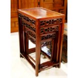 Set of four Chinese nesting tables, each with a floating top panel, the apron reticulated with