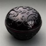 Chinese Peking glass circular box, of aubergine hue carved with meandering chilong to the