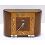 French Art Deco Bayard mantle clock, having a contoured walnut case and rising on brushed tubular