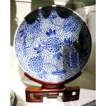 Chinese underglaze blue porcelain charger, featuring tendrils issuing large blossoms on a dense