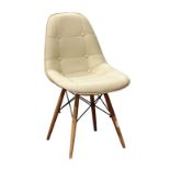 Charles and Ray Eames style side chair, having tufted cream upholstery, and rising on tapered