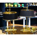 Pair of brass light fixtures, having an adjustable oval shade above the two electrified candle