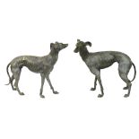 Pair of patinated bronze whippets, each depicted standing and gazing outward with a dignified
