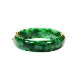 Jadeite and 14k yellow gold bracelet Featuring (2) carved jadeite segments, measuring