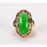 Jadeite, diamond and 14k yellow gold ring Featuring (1) jadeite saddle, measuring approximately 19 X