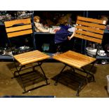 Pair of cafe folding chairs, the black painted metal frame with teak splats, 36"h; Provenance: