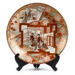 Japanese Kutani charger, Meiji period, figures in various activities in gilt and color in panels,
