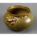 Chinese green glazed ceramic jar, with a rolled rim above a band of bosses, the shoulder of the