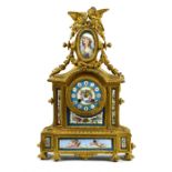French ormolu mounted clock, having a figural finial depicting birds, surmounting a Sevres style