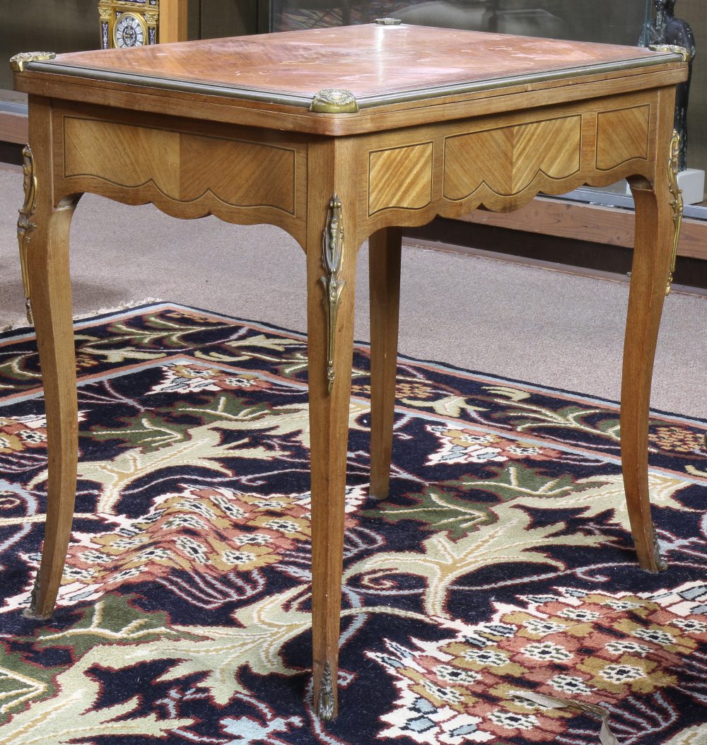 Louis XV style marquetry decorated games table, having a hinged floral decorated top opening to