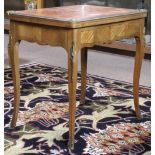 Louis XV style marquetry decorated games table, having a hinged floral decorated top opening to