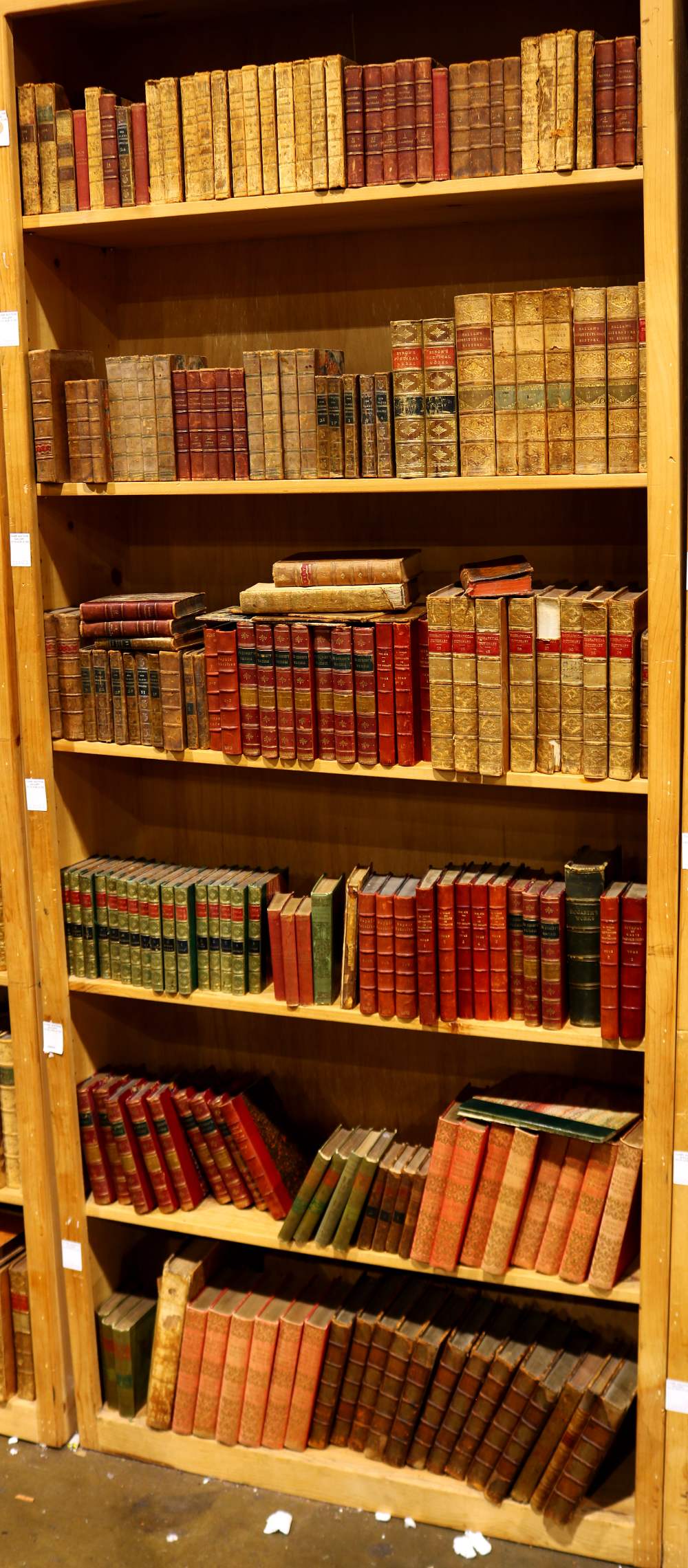 Six shelves of mostly leather bound books relating to literature, including "Le Vicomte de