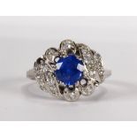 Sapphire, diamond and platinum ring Centering (1) round-cut sapphire, weighing approximately 1.20