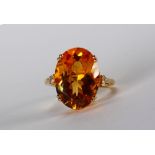 Citrine, diamond and 14k yellow gold ring Featuring (1) oval-cut citrine, weighing approximately