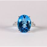 Blue topaz, diamond and 14k white gold ring Featuring (1) oval-cut blue topaz, weighing