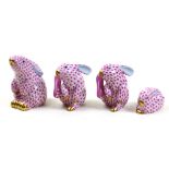 (lot of 4) Herend hand painted porcelain rabbits, each decorated in pink in the Fish Net pattern