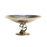 Tiffany & Co. sterling silver nut compote, after 1938, having a circular bowl on a dolphin form