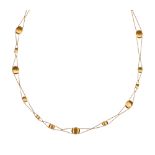 Nanis 18k yellow gold "Raindrop" necklace Composed of (18) textured, 18k yellow gold oval "Raindrop"