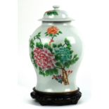 Chinese enameled lidded porcelain jar, featuring peonies on the globular body above the splayed
