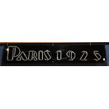 Art Deco style neon sign, having red letters and numbers reading "Paris 1925," evoking the time of