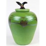 Iridescent art glass lidded sculptural jar depicting an apple, having a green body with heart shaped