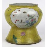 Chinese yellow sgraffito ground porcelain vase, featuring two bird-and-flower reserves, on a