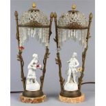 Pair of German Porcelain figural lamps, each with a beaded shade above the white porcelain figure in