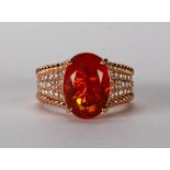 Mexican fire opal, diamond and 14k rose gold ring Featuring (1) oval-cut opal, weighing