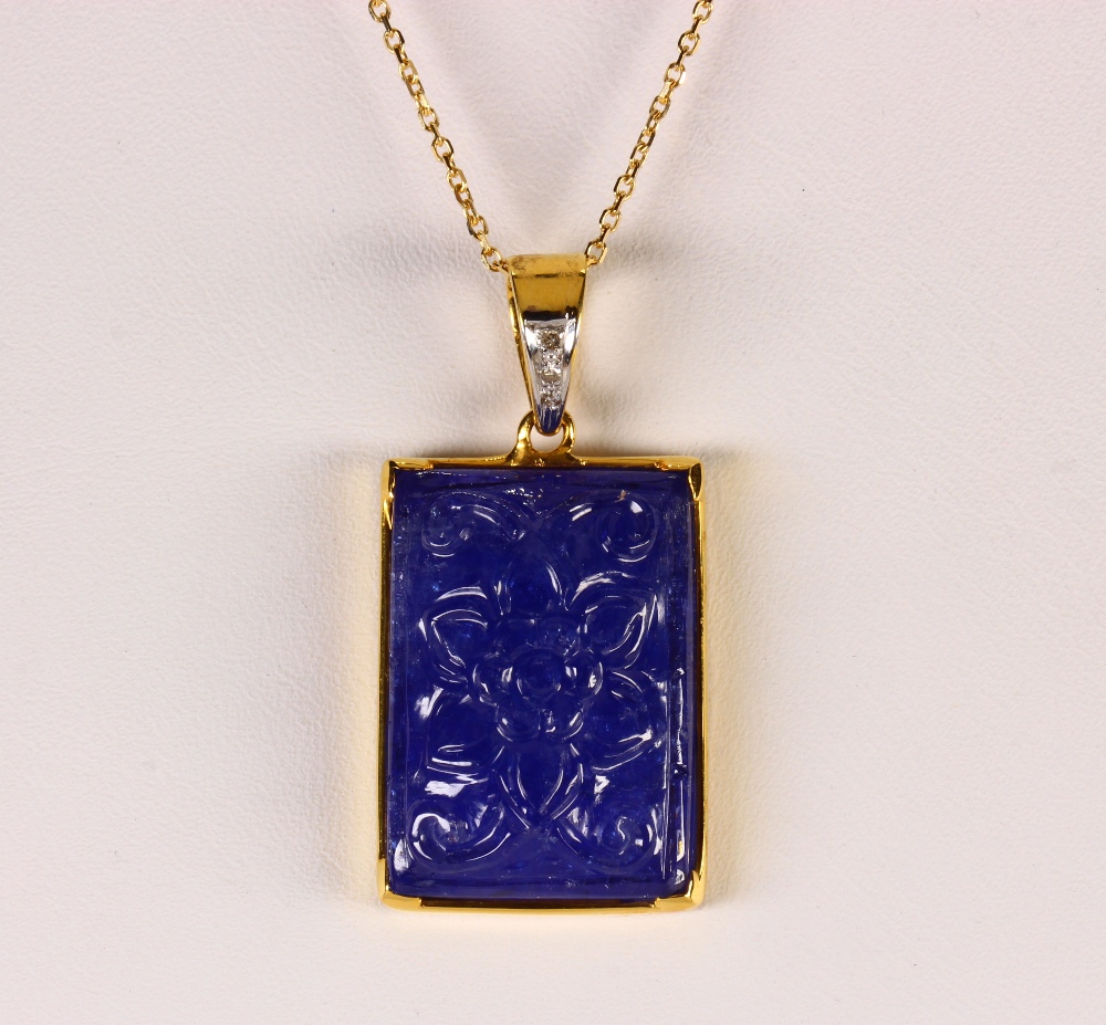 Tanzanite, diamond and 18k yellow gold pendant-necklace Featuring (1) carved foliate motif