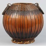 Japanese Ikebana flower arrangement basket, globular form with a ring on either side, with a