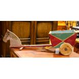Folk art wooden toy wagon, the horse drawn wagon having painted green and red, with (2) wheels, 12"h