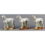 (lot of 3) German porcelain greyhound sculptural group, each white dog with a gilt enamel collar and