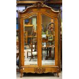 Louis XV style walnut armoire, having a rocaille crest centered with a figural medallion, above