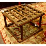 Modern occasional table, having a square glass top, above cylindrical legs, 14"h x 21"dia.