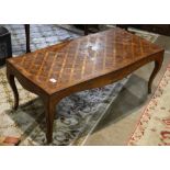 French provincial style low table, the rectangular top having a parquetry form pattern and rising on