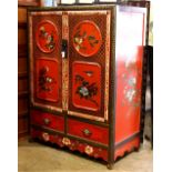 Chinese polychrome red ground wood cabinet, fronted by a pair of hinged doors with bird-and-flower