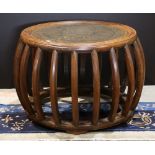 Chinese wooden drum form low table, the top with stylized gilt roundels, within a ridged edge,