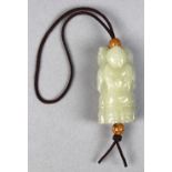 Chinese hardstone children toggle, with three standing children each holding an auspicious item,