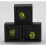 (Lot of 3) Unmounted peridots Including 3) unmounted cushion-cut peridots, each weighing 3.09